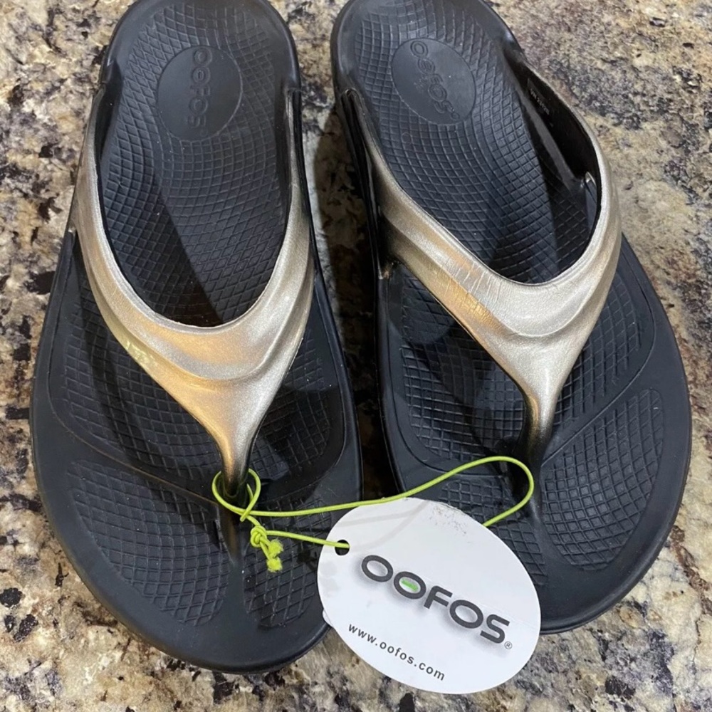 OOFOS Women's Black Flip-Flops with Metallic Gold Straps